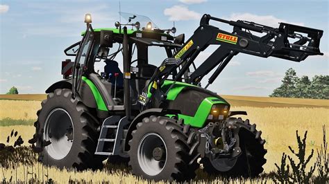 Zdjęcie ciągnika Deutz-Fahr Agrotron z szybami bez nadruku i pionowo zorientowaną klamką drzwi