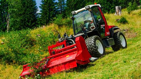 A Sauerburger Grip4-140 tractor, with emphasis on its robust design and the capability to mount a front loader. The image should highlight its unique chassis for slope work.