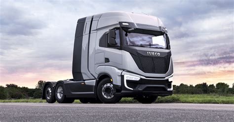 The Iveco logo with a modern heavy-duty truck in the background