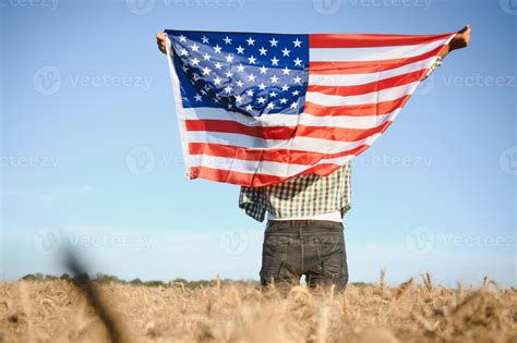 Thematic photo of a modern farmer with patriotic and catholic symbols in the background