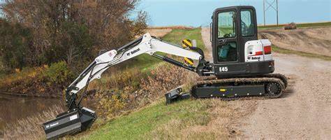 Thematic photo of a Bobcat E45 excavator with its arm extended, illustrating a maintenance scenario