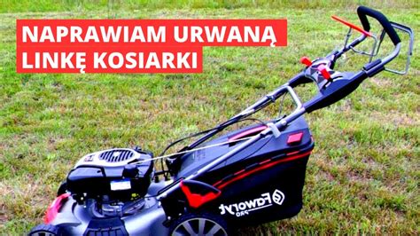 Zdjęcie zbliżenie na rączkę kosiarki spalinowej z widocznymi dźwigniami sterującymi i linkami