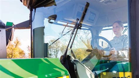 Photo showing a tractor windshield being installed, highlighting tools and precision