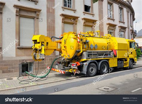 Thematic photo of a modern sewerage truck on an urban street