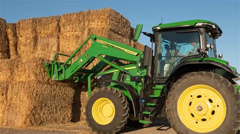 Thematic photo of John Deere tractor with front loader in a farm setting