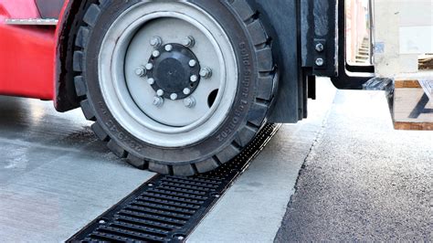 Thematic photo of a leveling grate for a forklift in action, leveling soil.