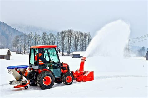 Traktor odśnieżarka w akcji, odśnieżający duży parking