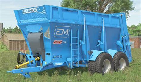 The Euromilk Buffalo RX tandem spreader working in a field, showing its large size and spreading action.