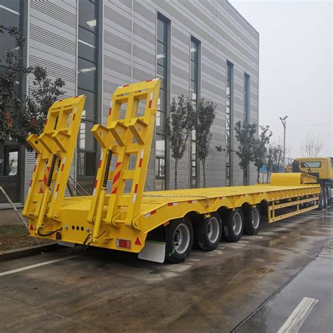 Photo of PTM PT-18 low-bed trailer transporting heavy machinery