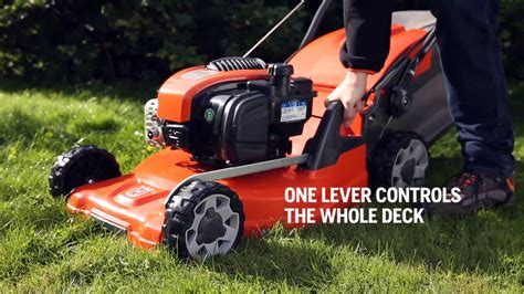 Photo of a lawnmower with visible central height adjustment lever