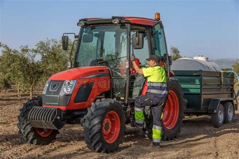 Thematic photo of a Tuber tractor in an orchard or performing municipal work.
