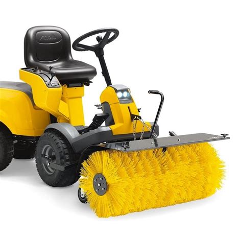 Photo of a STIGA sweeper with a brush, operating in winter conditions