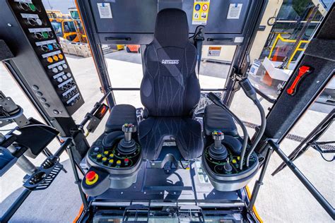 Interior view of the JCB JS175W operator cabin, showing the ergonomic controls and adjustable seat.