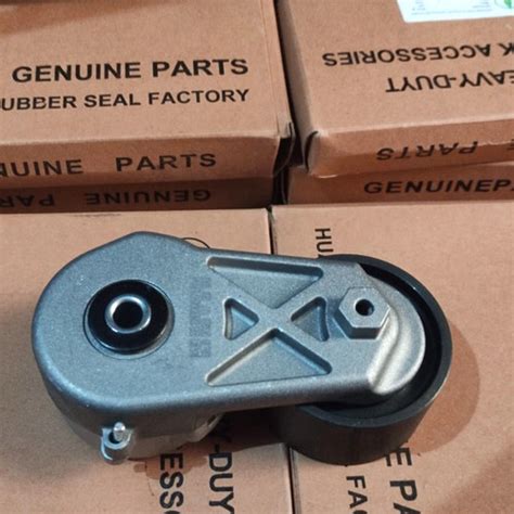 Thematic photo of XCMG loader parts, highlighting a tensioner pulley