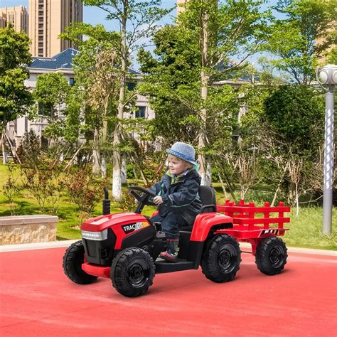 Thematic photo of a child driving a Baby Mix tractor with a trailer.