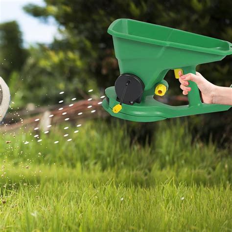 Thematic photo of a person using a hand spreader in a garden
