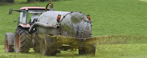 Photo of an agricultural slurry tanker spreading slurry on a field
