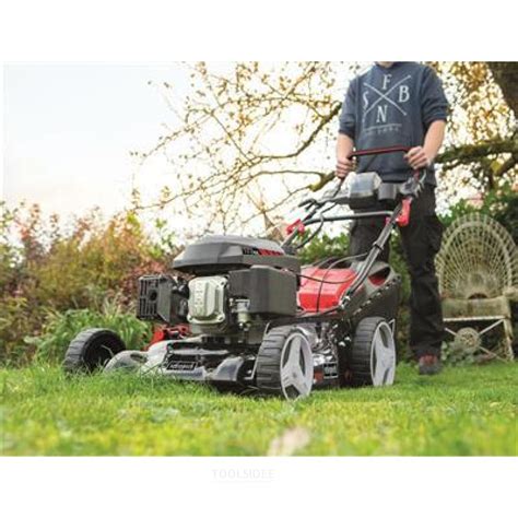 The Scheppach MS173-51 lawnmower in action, with a focus on its modern design and ease of use.