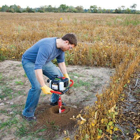 Thematic photo of a person operating an earth auger