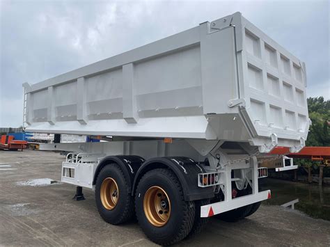 Photo of a steel tipper semi-trailer in a construction site environment