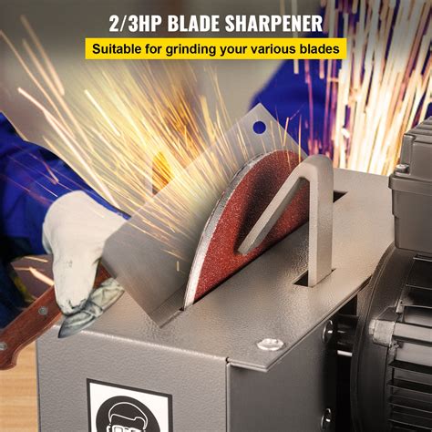 Photo of a person sharpening a flail mower blade on a bench grinder