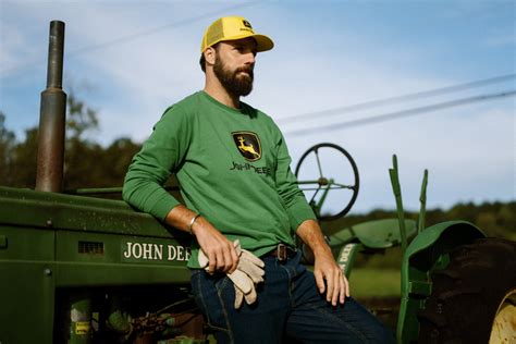 Thematic photo of a person wearing John Deere workwear on a farm