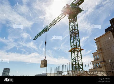 Thematic photo of a Jelcz mobile crane in operation, lifting materials on a construction site