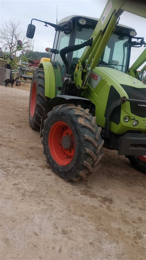 Ciągnik Claas AXOS 2 z zamontowanym ładowaczem czołowym