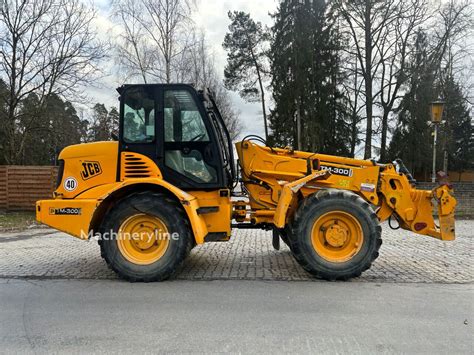 Schemat budowy ładowarki przegubowo-teleskopowej JCB TM 300 z zaznaczonym przegubem centralnym