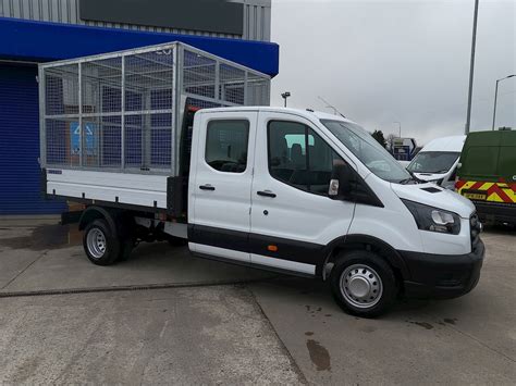 Thematic photo of a delivery van with a tipper body working on a construction site