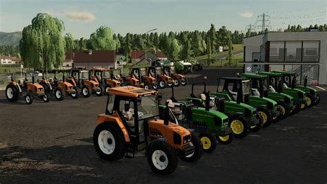 Ciągniki Renault Ceres i John Deere 3000 pracujące z ładowaczami czołowymi