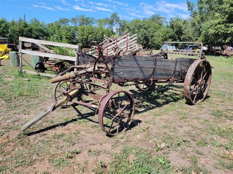 Thematic photo of a vintage manure spreader working in a mountainous landscape