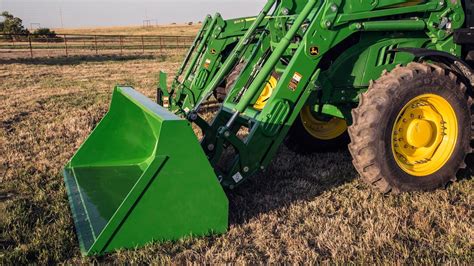 Thematic photo of a front loader with an attachment working in a field