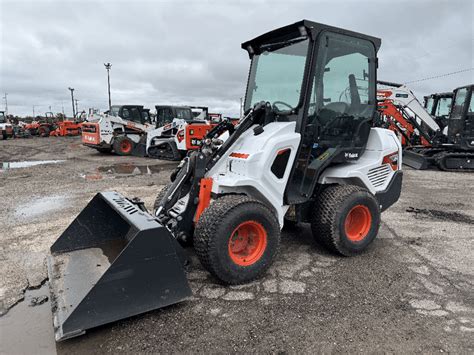 Bobcat L28 working in a narrow pathway, highlighting its compact size