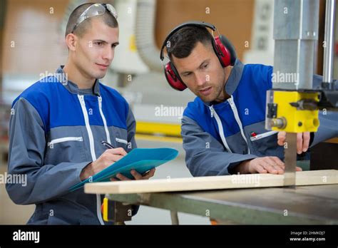 Photo of an instructor demonstrating machine operation to students