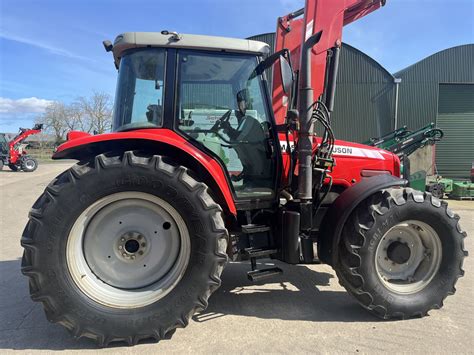 Thematic photo of Massey Ferguson 5470 tractor working on a farm