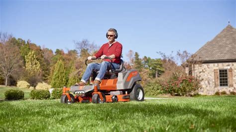 Thematic photo of a person driving a lawn tractor in a large garden