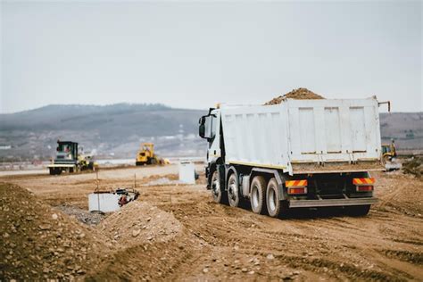Thematic photo of a dump truck working on a construction site or road maintenance.