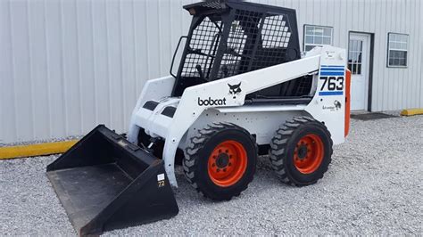 Thematic photo of a Bobcat 763 H skid steer loader working on a construction site