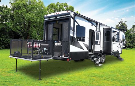 Photo: Fifth-wheel toy hauler with its rear ramp open, revealing internal garage space