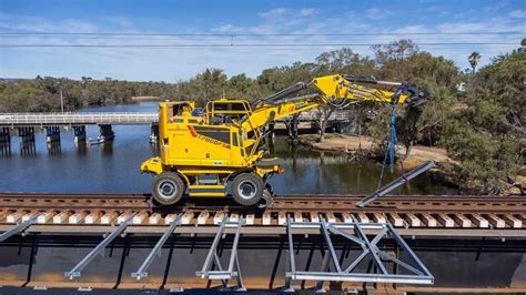 The Colmar T 7000 FS rail-road excavator at work