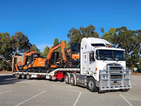 A low loader trailer transporting heavy construction machinery
