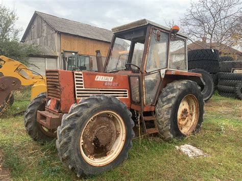 Thematic photo of an old Fiat agricultural tractor, possibly a Fiat 680, working in a field