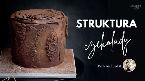 Tematyczne zdjęcie gotowej figurki traktora na torcie, ozdobionej jadalnym piaskiem i listkami.