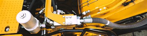 Zdjęcie elektrozaworu z cewkami w układzie hydraulicznym JCB