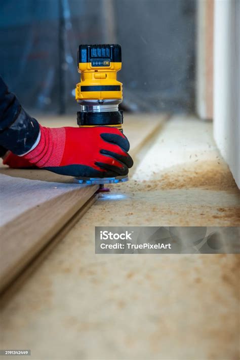 Thematic photo: a person using a router on a wooden board