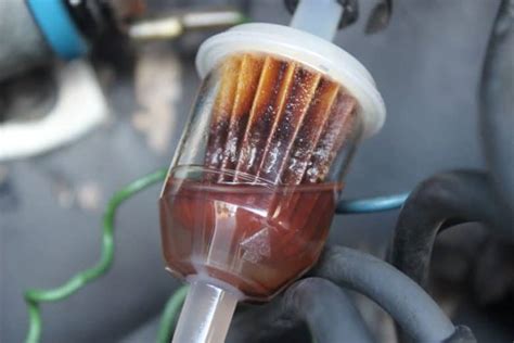 Photo of a dirty fuel filter being replaced