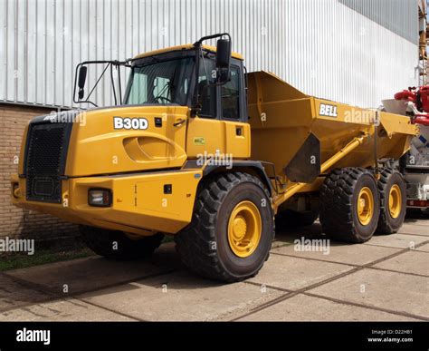The Bell B30D articulated dump truck in action on a construction site, moving earth
