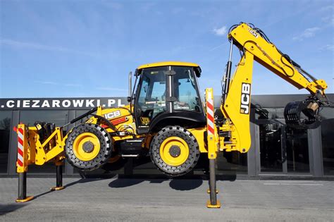 Koparko-ładowarka JCB 5CX PRO na placu budowy, wykonująca ciężkie roboty ziemne