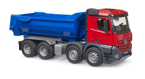 The Bruder Mercedes Arocs dump truck toy in action, carrying sand or gravel.